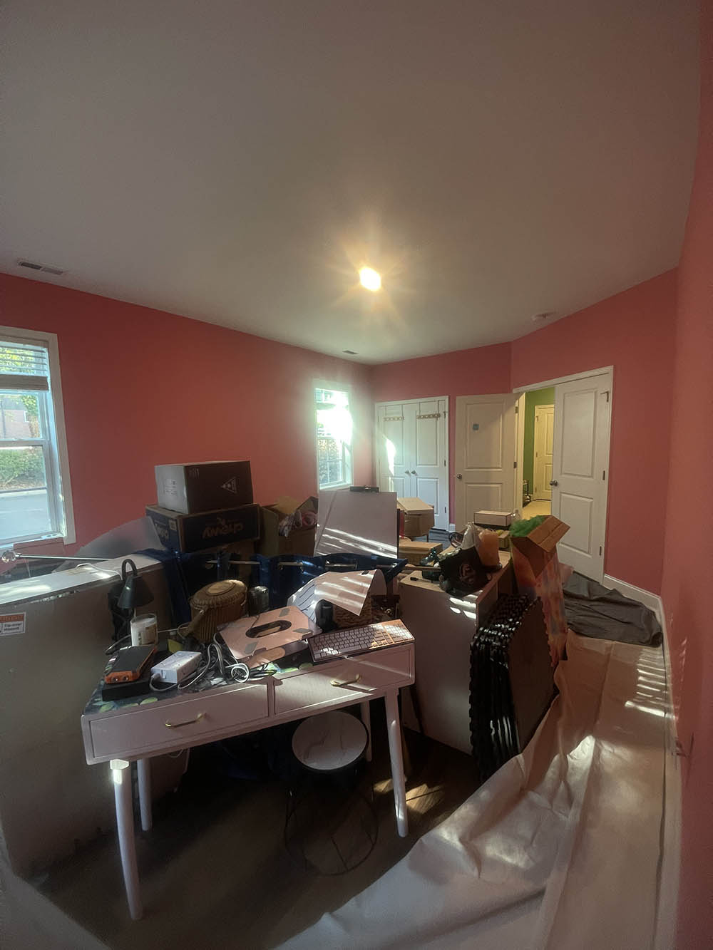 Bedroom interior showing natural daylight across repaired ceiling and walls